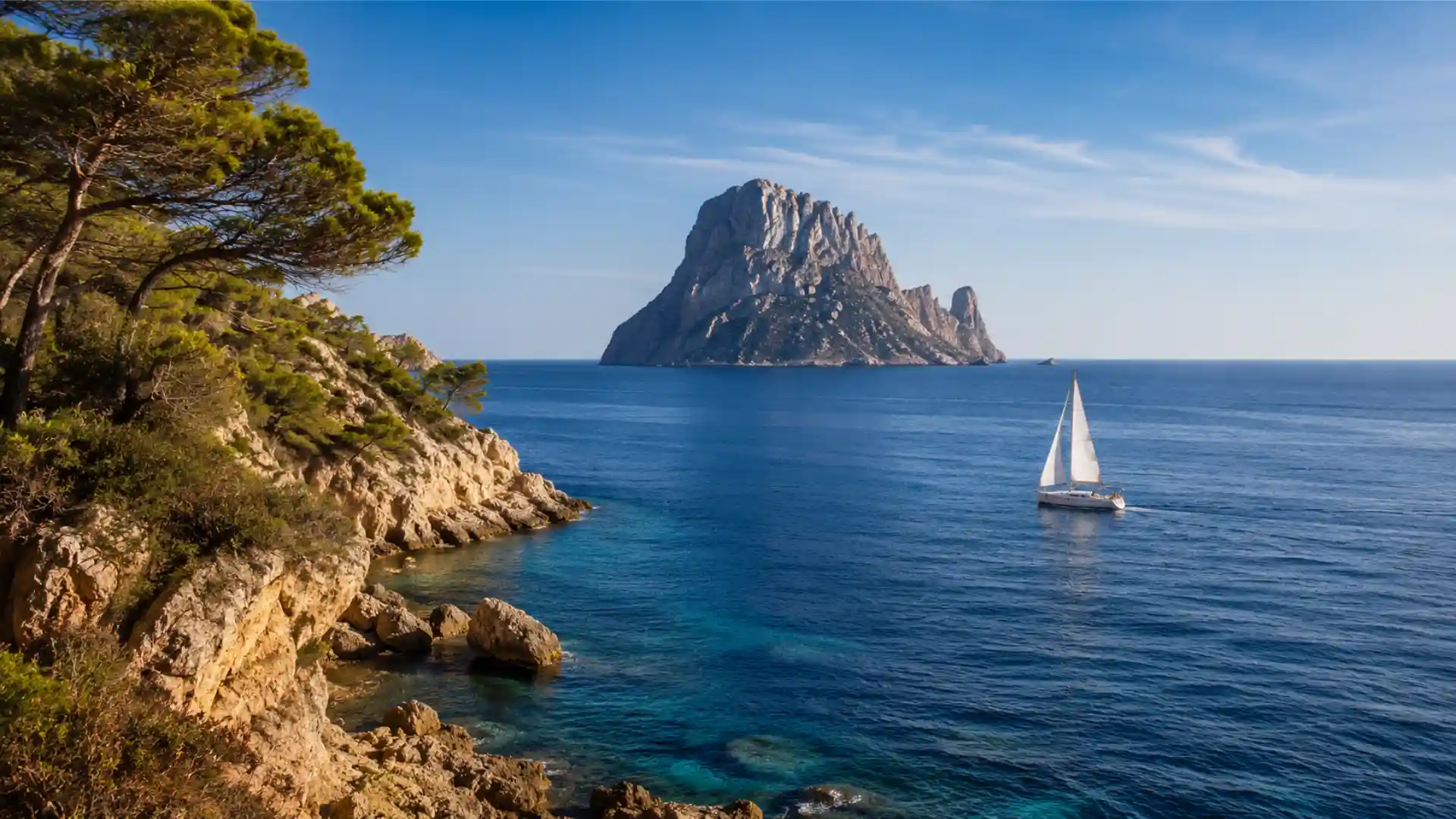 Sailboat sailing off Es Vedrà with thermal winds in Ibiza